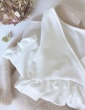 patron de couture Modèle Eugenie version blouse dans un tissu blanc présenté plié sur un pull Des Petits Hauts nude