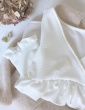 patron de couture Modèle Eugenie version blouse dans un tissu blanc présenté plié sur un pull Des Petits Hauts nude